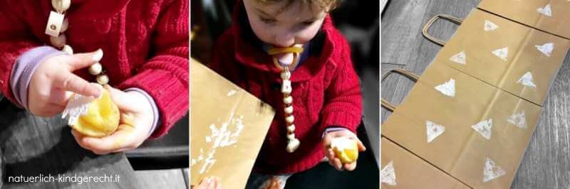 Kleinkind bestempelt mit einem Kartoffelstempel Geschenktüten